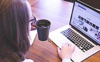 A woman using a website on a laptop