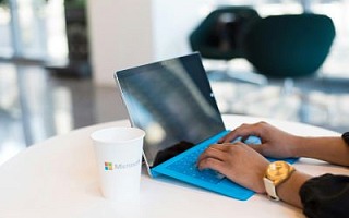 Someone with a Microsoft mug using a Surface PC