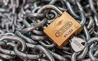 A padlock resting on some chains